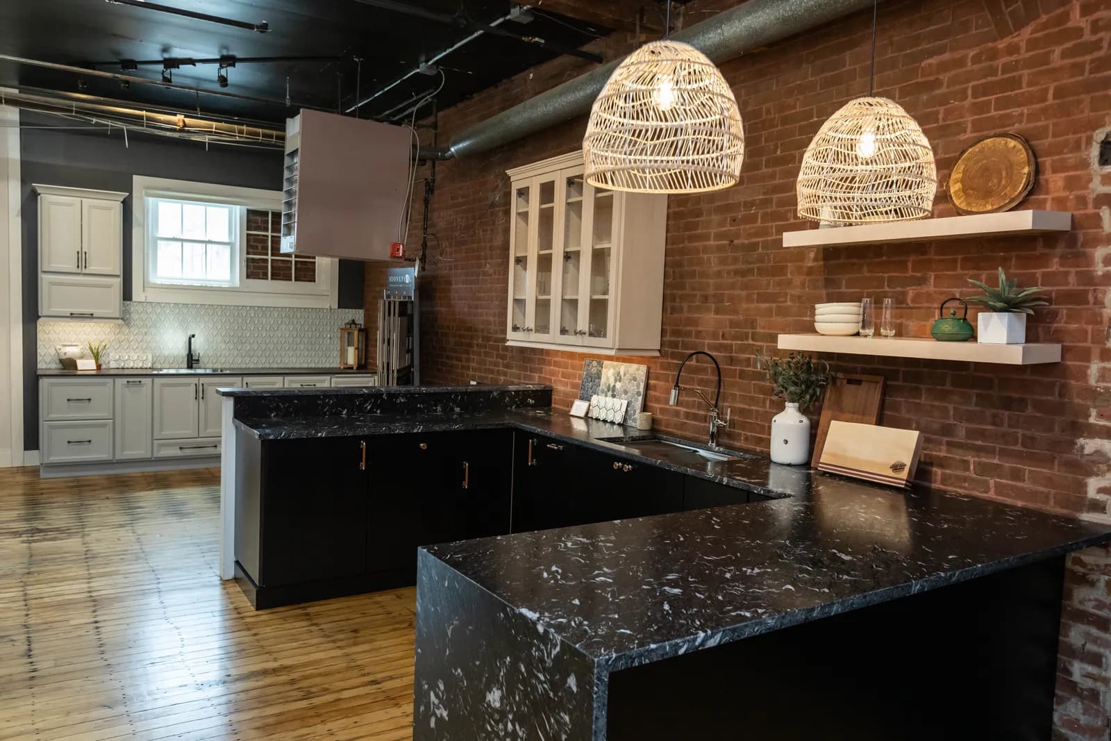 Kitchen display with brick wall and pendant lights